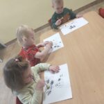 Dzieci odbijają kropki na papierze stempelkami