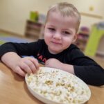 Dzieci jedzą popcorn na Dzień Popcornu